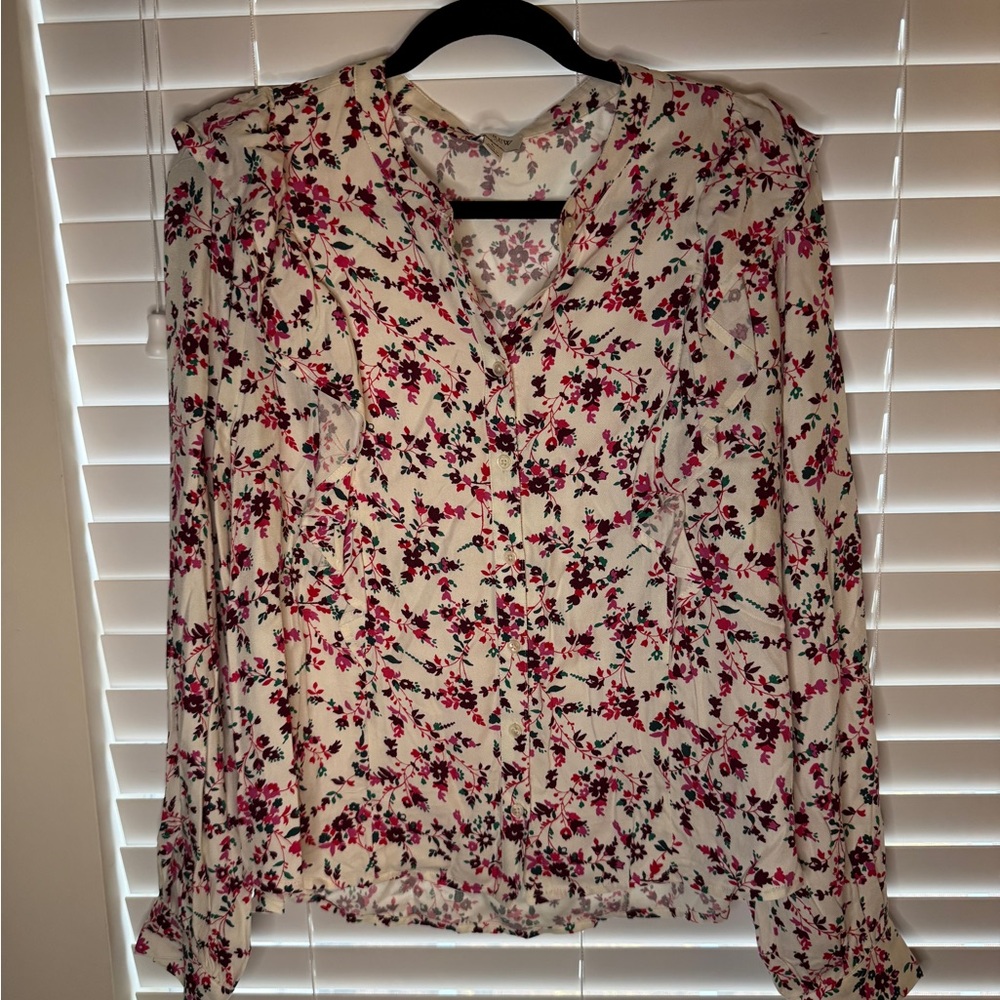 Floral button down. Ruffle in the front. Soft fabric. Button closure on sleeves.